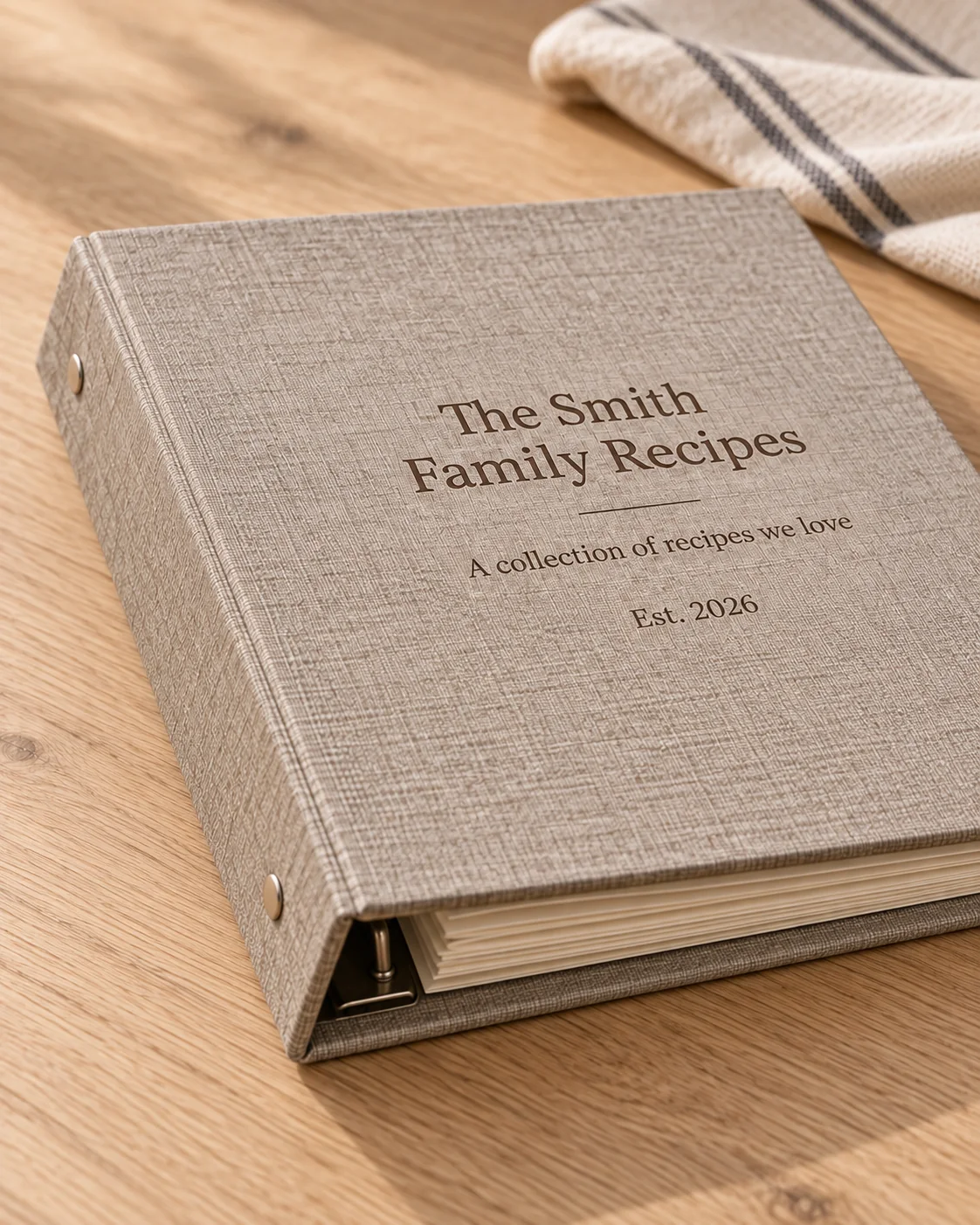 Close view of the recipe binder spine, cover texture, metal rivets, and ring mechanism